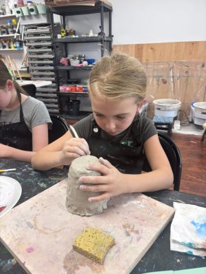 Children working on a pottery and sculpture art project at Vivo Art Studio in Palm Coast, Florida.